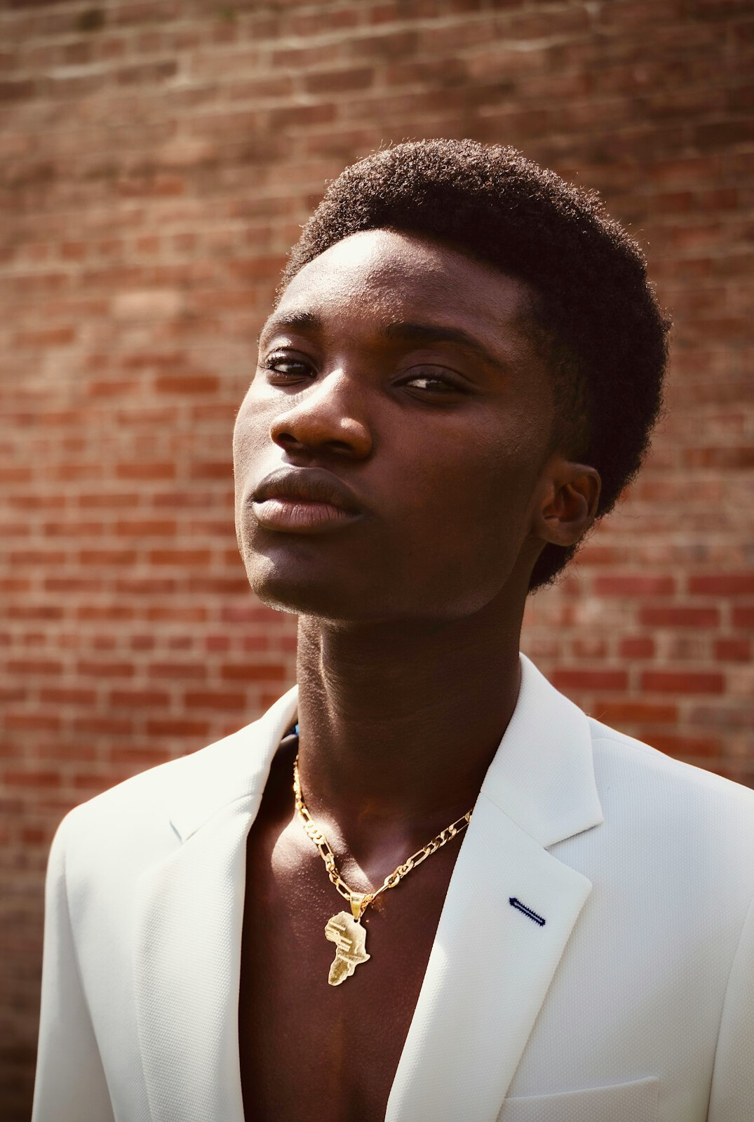 Portrait of a Black man with short hair in a suit jacket