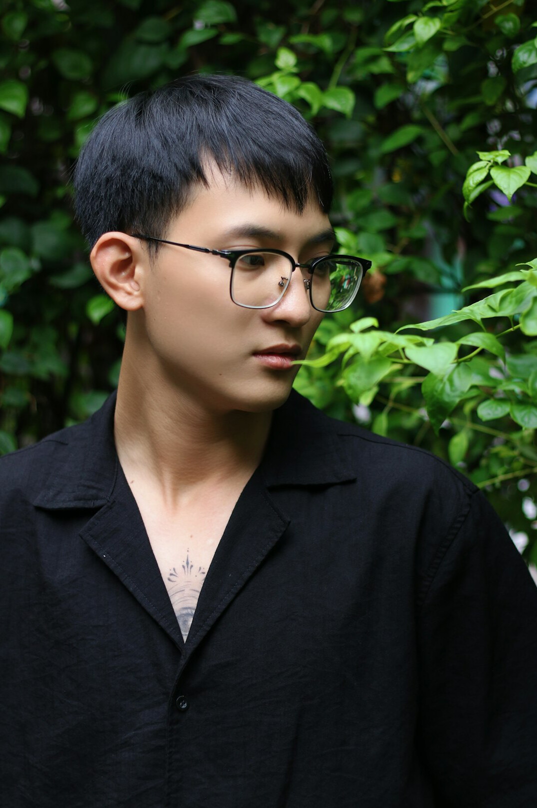 Portrait of a man with glasses and short dark hair in a shirt