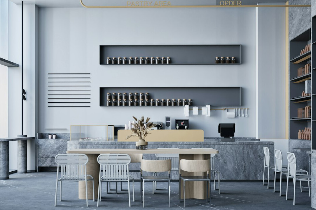 Reception area of a modern office with a wooden desk and plants
